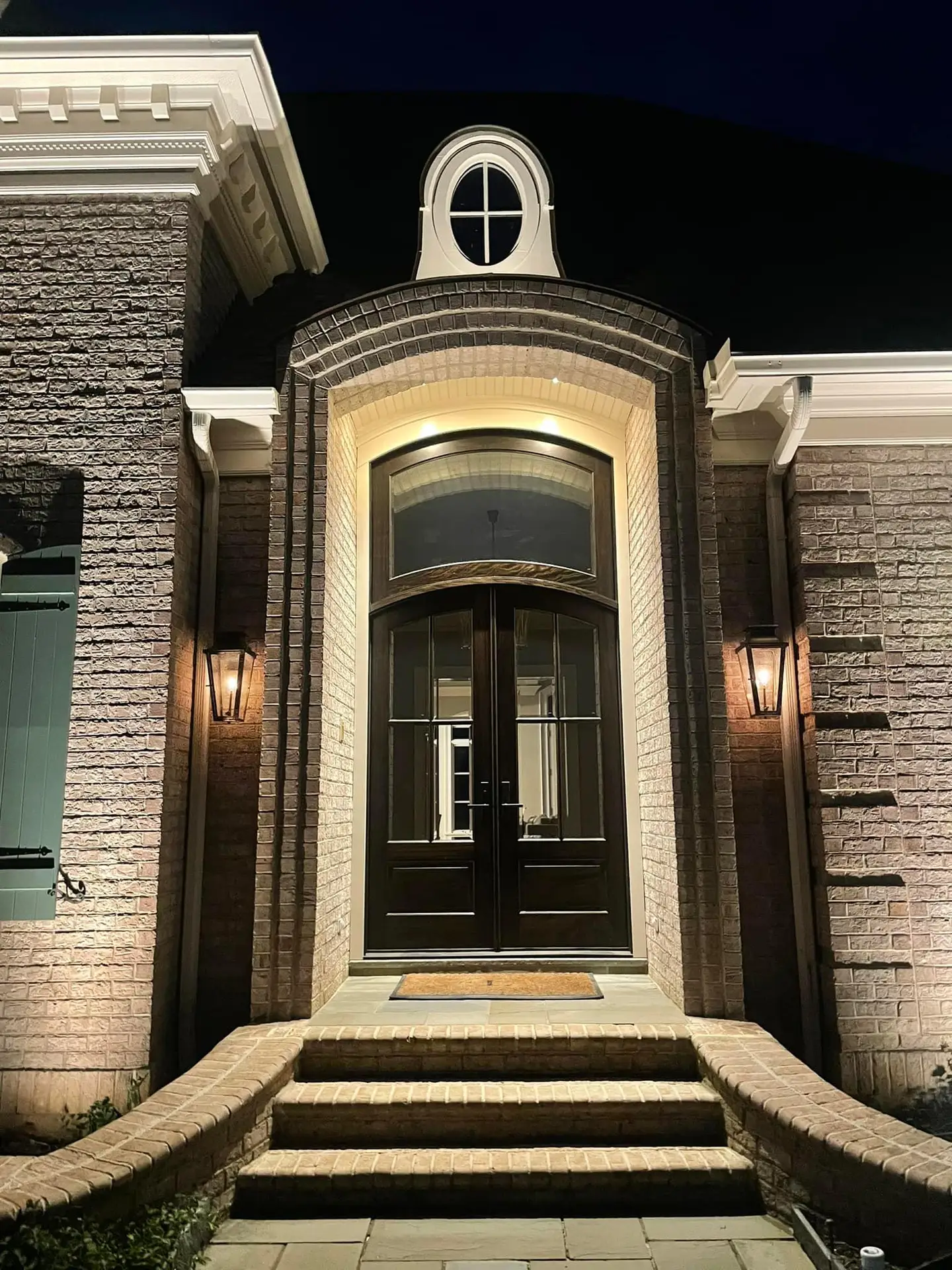 Architectural outdoor lighting illuminating a home's front entrance in Midlothian, Virginia